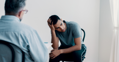 two men sitting in a room during cognitive behavioral therapy